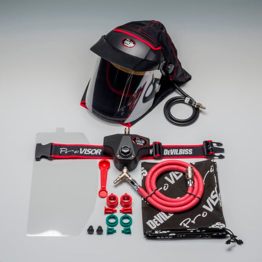 Devilbiss spray painting kit with helmet, hose, and tools on a gray background